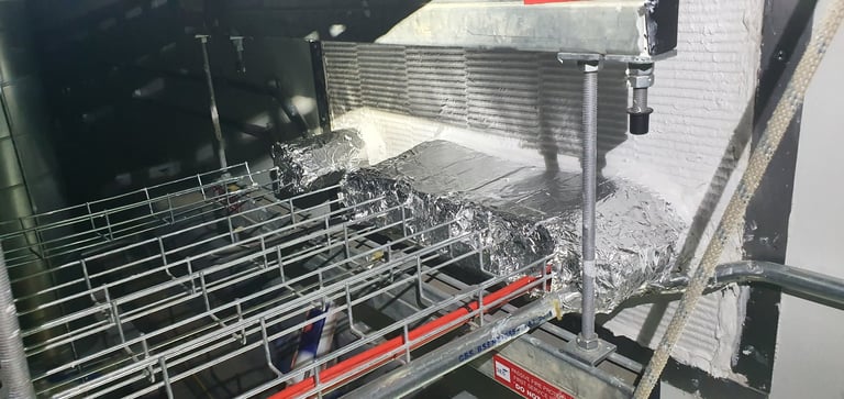 Open dishwasher with clean dishes and utensils in racks drying inside
